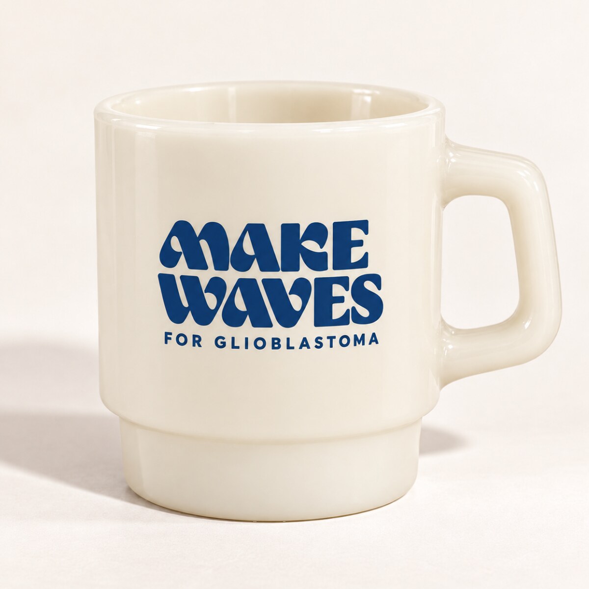 Cream milk glass cup with bright blue Make Waves logo