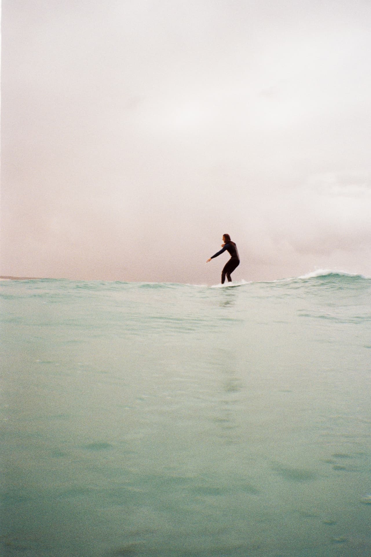 A surfer riding a small wave